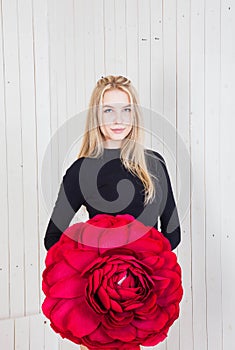 Girl in a black bodysuit and holding a red rose