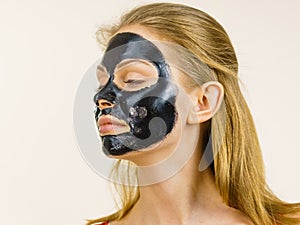 Girl black carbo peel off mask on face