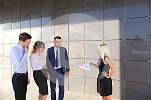 Girl in black dress holds paper and explains, makes remarks, exp