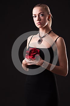 Girl in black dress with red rose