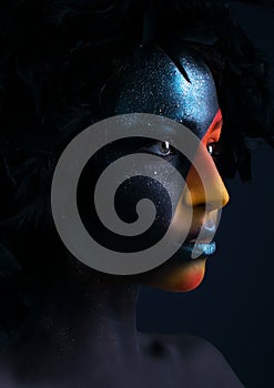 Girl with black make-up and colorful bodypainting