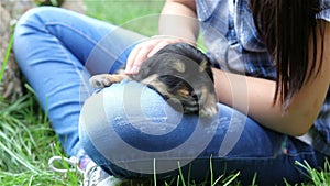 Girl with black puppy.