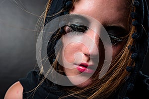 Girl in black scarf looking down