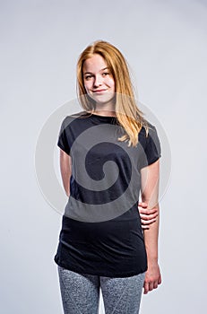 Girl in black t-shirt and fitness leggings, studio shot