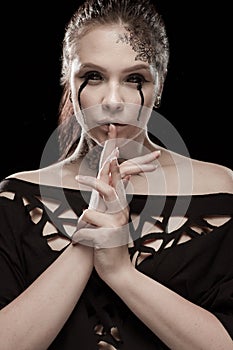 Girl with black tears from eyes and lace pattern on face and neck