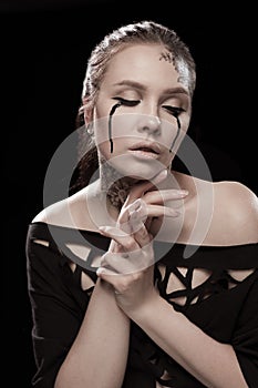 Girl with black tears from eyes and lace pattern on face and neck