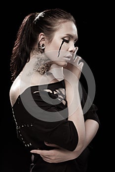 Girl with black tears from eyes and lace pattern on face and neck