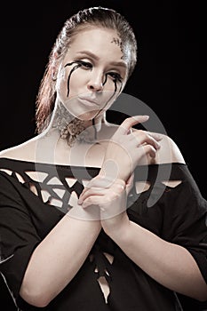 Girl with black tears from eyes and lace pattern on face and neck