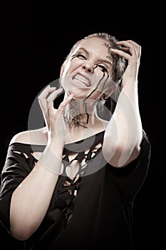 Girl with black tears from eyes and lace pattern on face and neck