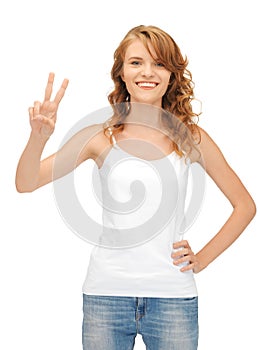 Girl in blank white t-shirt showing victory sign