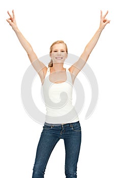 Girl in blank white t-shirt showing victory sign