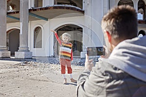 Girl blogger records film and makes selfie over abandoned building for her channel, local tourism