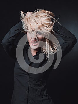 The girl with blond hair on black background