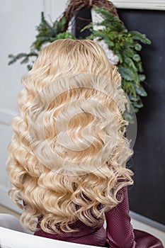 girl with blonde curly Healthy Wavy hair. Back view