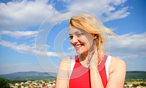 Girl blonde lady smiling enjoy freedom and fresh air wind blue sky background. Woman red dress feels carefree and free