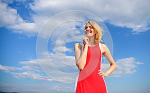 Girl blonde lady smiling enjoy warm sunlight blue sky with clouds background. Girl playful mood coquette. Sunlight