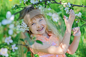 Girl in blooming apple tree garden