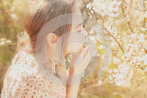 Girl and the blossoming bush at spring