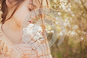 Girl and the blossoming bush at spring