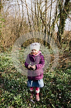 Girl and blossoming white snowdrop photo