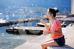 Girl blow bubbles on beach