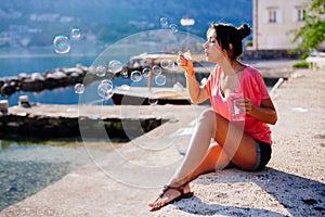 Girl blow bubbles on beach