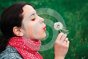 Girl blow on Dandelion