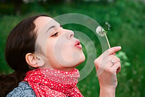 Girl blow on Dandelion