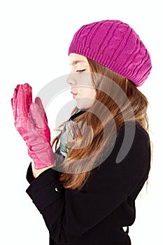Girl blow on numb hands isolated over white photo