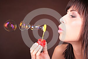 Girl blowing blow bubbles - seifenblasen