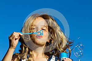 Girl blowing bubbles photo