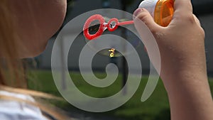 Girl blowing bubbles outdoor