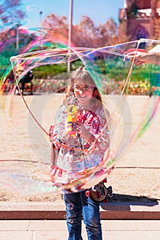 Girl blowing bubbles in the park