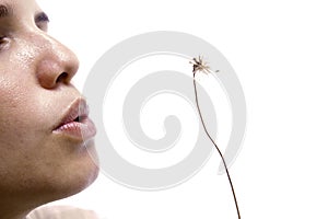 Girl blowing dandelion