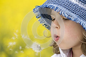 Girl blowing dandelion