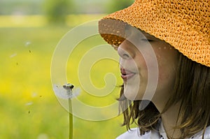 Girl blowing dandelion