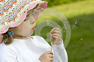 Girl blowing dandelion