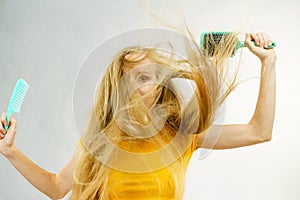 Girl blowing hair with comb brush