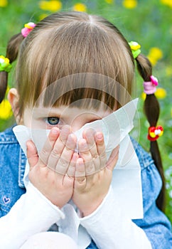 Girl is blowing her nose