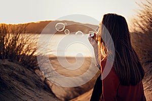 Girl blowing making soap bubbles