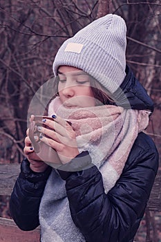 Girl blowing on a mug