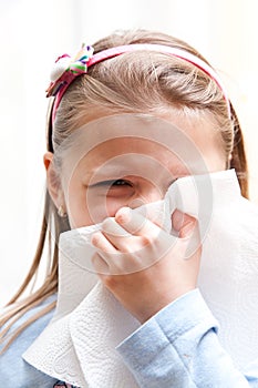 Girl blowing nose