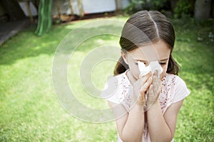 Girl Blowing Nose In Backyard