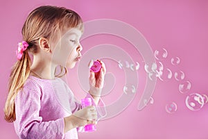 Girl blowing soap bubbles