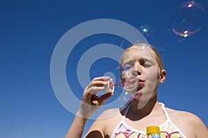 Girl blowing soap bubbles