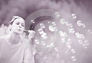 girl blowing soap bubbles