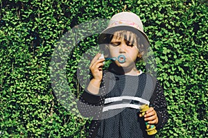 Girl blowing soap bubbles