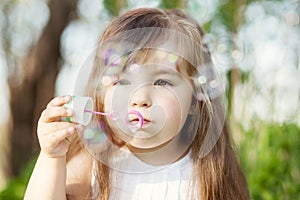 Girl blowing soap bubles