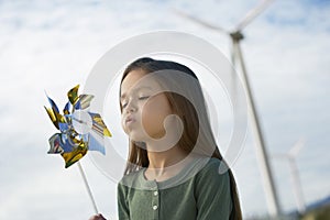 Girl Blowing Toy Windmill