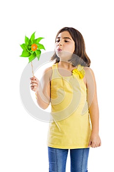 Girl blowing a windmill